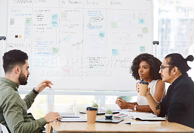 Buy stock photo Shot of a group of young businesspeople having a meeting in a modern office