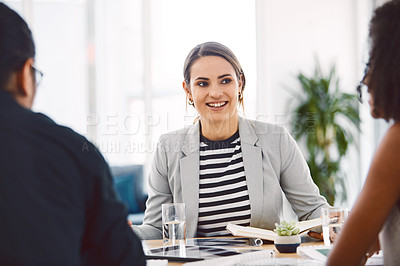 Buy stock photo Shot of a group of young businesspeople having a meeting in a modern office