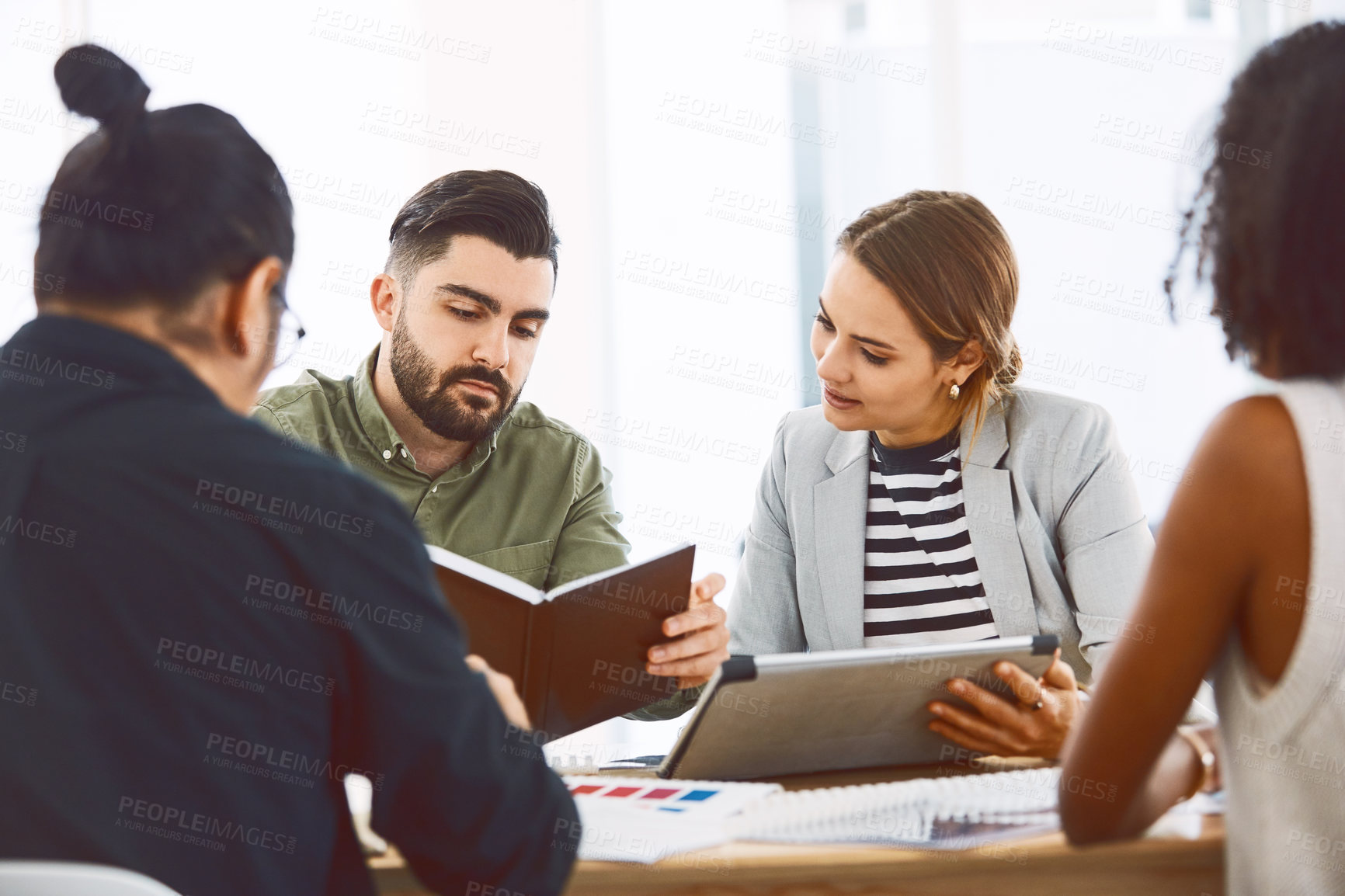 Buy stock photo Team, meeting and notebook in office with tablet, review graphic design or idea planning for project. Digital designer, people and research in agency with tech, planner and check media for marketing.