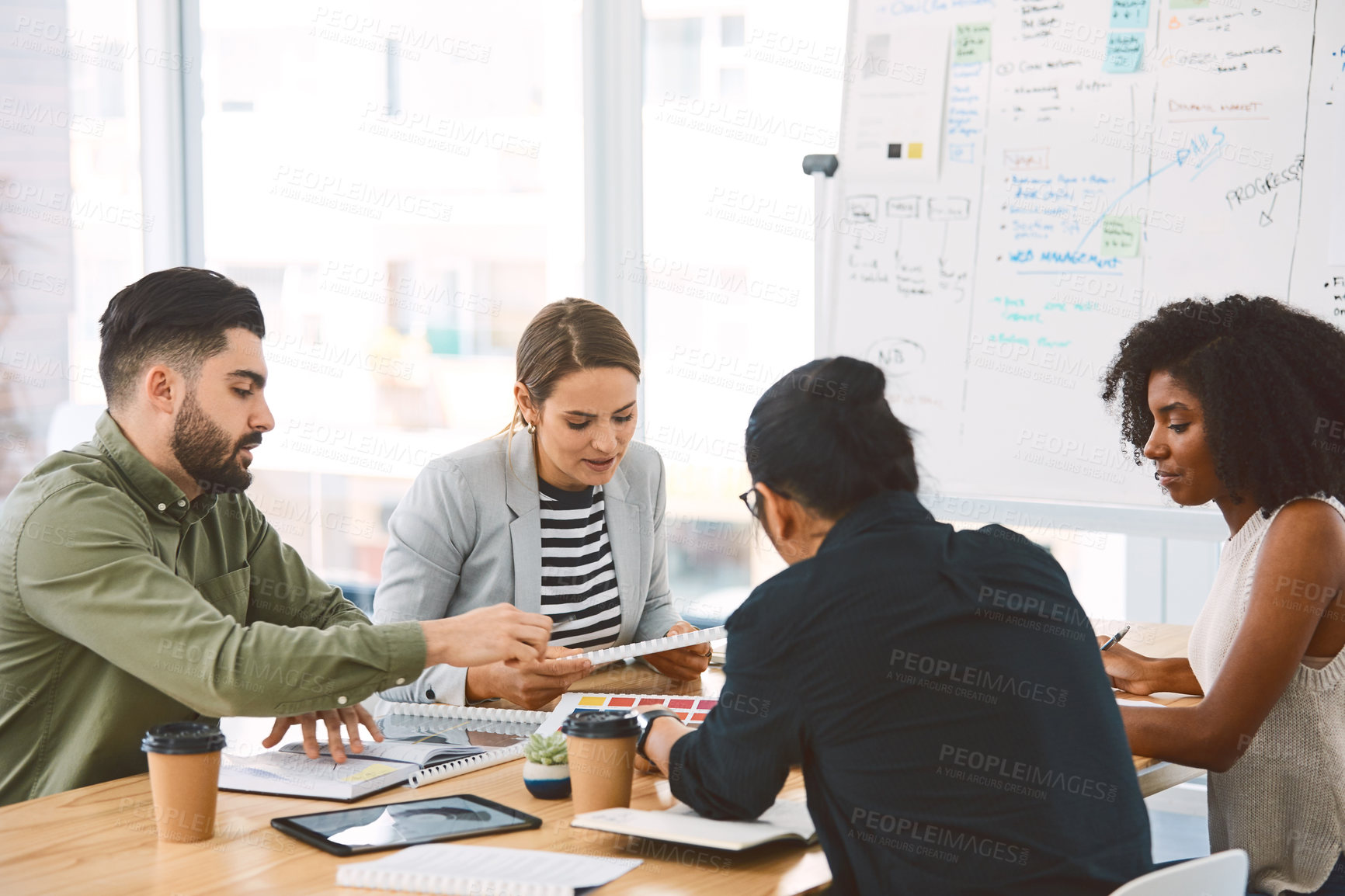 Buy stock photo Shot of a group of young businesspeople having a meeting in a modern office