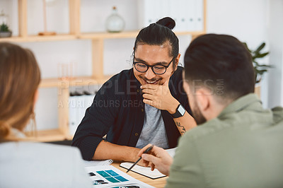 Buy stock photo Shot of a group of young businesspeople having a meeting in a modern office