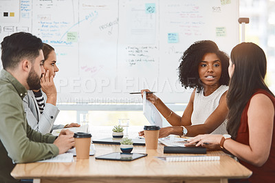 Buy stock photo Shot of a group of young businesspeople having a meeting in a modern office