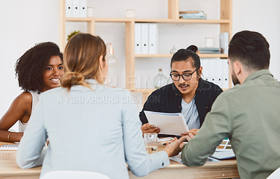 Buy stock photo Shot of a group of young businesspeople having a meeting in a modern office