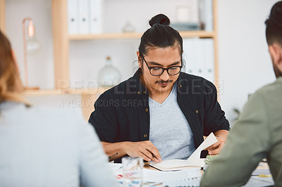 Buy stock photo Shot of a group of young businesspeople having a meeting in a modern office