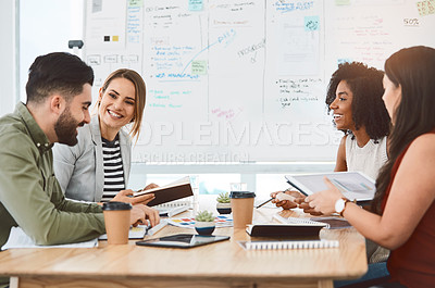 Buy stock photo Shot of a group of young businesspeople having a meeting in a modern office