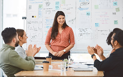 Buy stock photo Shot of a group young businesspeople clapping during a presentation in a modern office