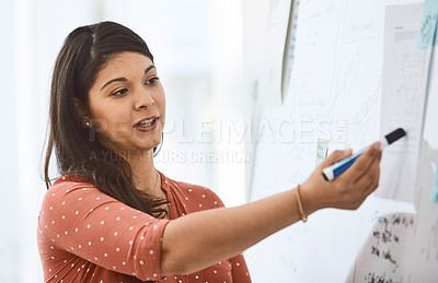 Buy stock photo Shot of a young businesswoman delivering a presentation in a modern office