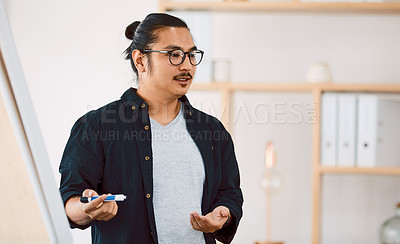 Buy stock photo Shot of a young businessman delivering a presentation in a modern office