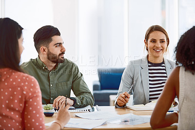 Buy stock photo Shot of a group of young businesspeople having a meeting in a modern office