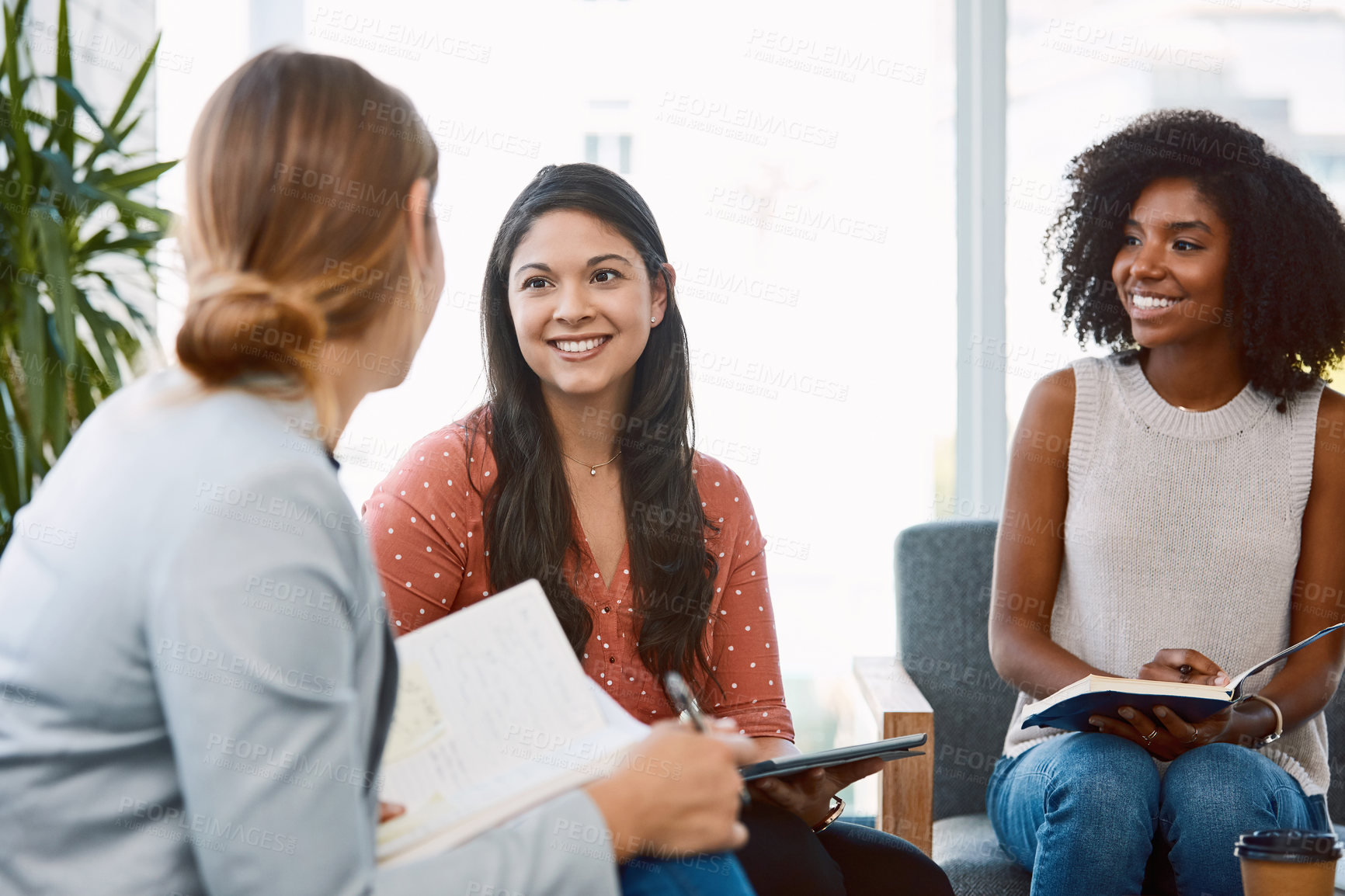 Buy stock photo Shot of a group of young businesspeople having a meeting in a modern office