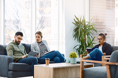 Buy stock photo Shot of a group of young businesspeople having a meeting in a modern office