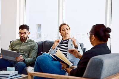 Buy stock photo Shot of a group of young businesspeople having a meeting in a modern office