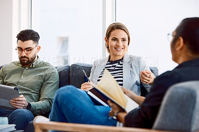 Buy stock photo Shot of a group of young businesspeople having a meeting in a modern office