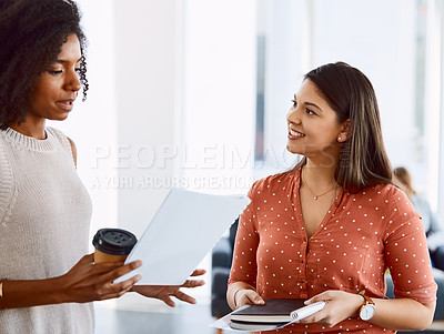 Buy stock photo Shot of two young businesswomen having a discussion in a modern office