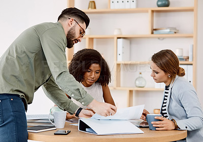 Buy stock photo Shot of a group of young businesspeople having a meeting in a modern office