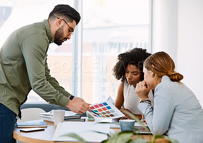 Buy stock photo Shot of a group of young businesspeople having a meeting in a modern office