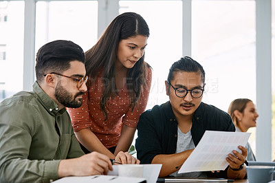 Buy stock photo Shot of a group of young businesspeople having a meeting in a modern office