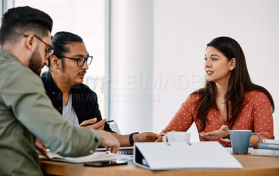 Buy stock photo Shot of a group of young businesspeople having a meeting in a modern office