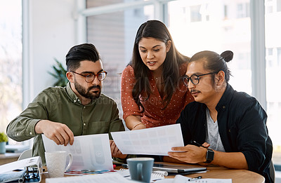 Buy stock photo Shot of a group of young businesspeople having a meeting in a modern office