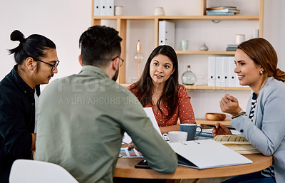 Buy stock photo Shot of a group of young businesspeople having a meeting in a modern office