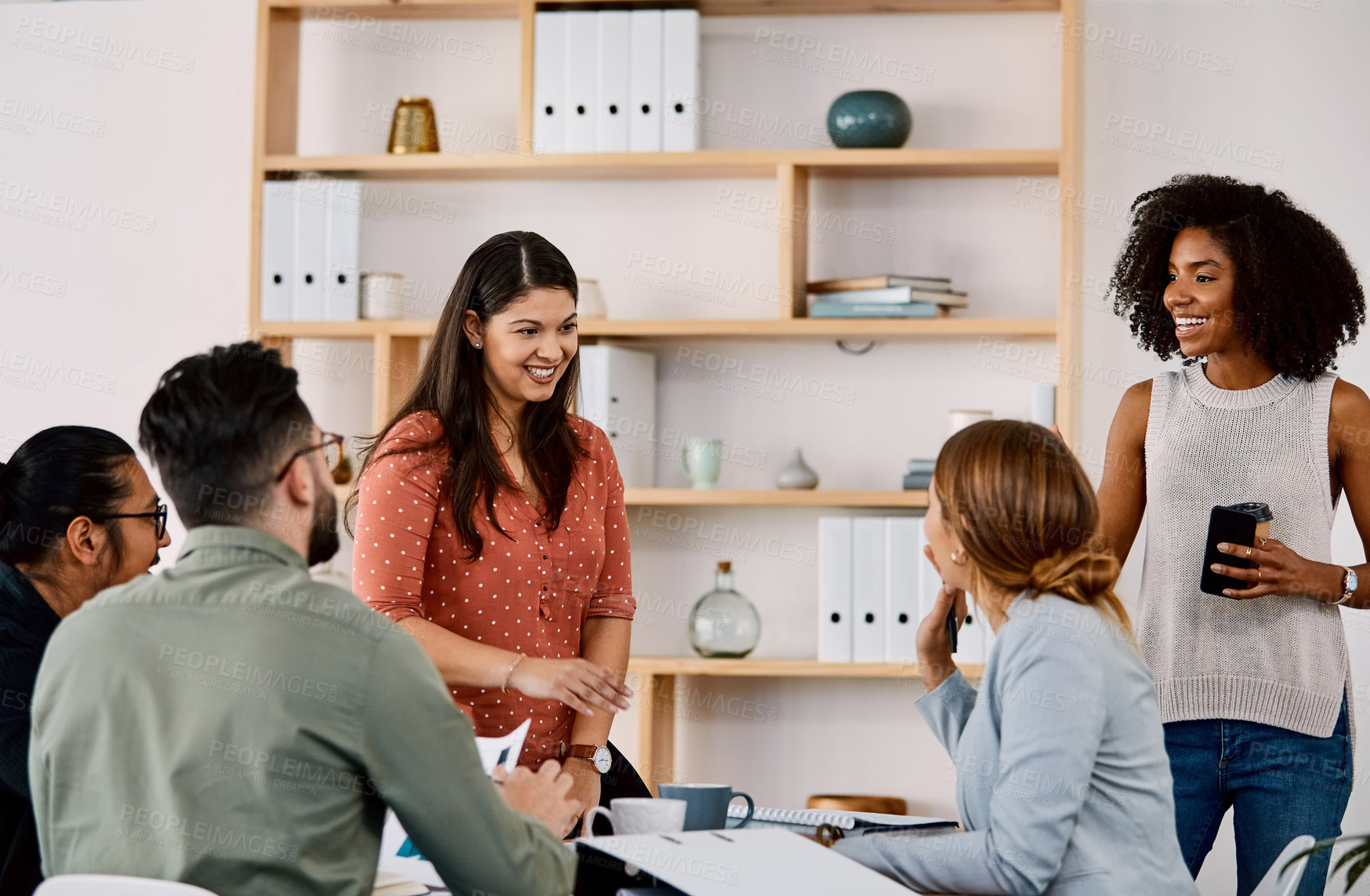Buy stock photo Shot of a group of young businesspeople having a meeting in a modern office