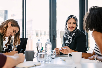 Buy stock photo Shot of three young businesswomen having a meeting together at work