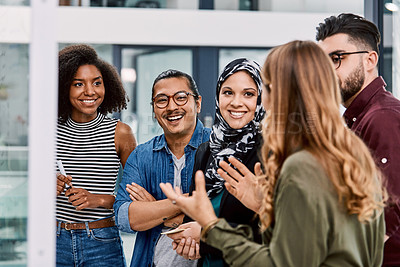 Buy stock photo Shot of a group of young businesspeople planning and writing notes on a glass wall in an office at work