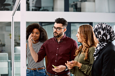 Buy stock photo Shot of a group of young businesspeople planning and writing notes on a glass wall in an office at work