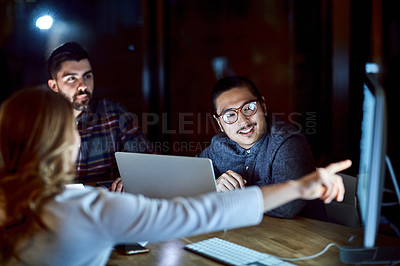 Buy stock photo Shot of a group of young businesspeople having a meeting during a late night at work