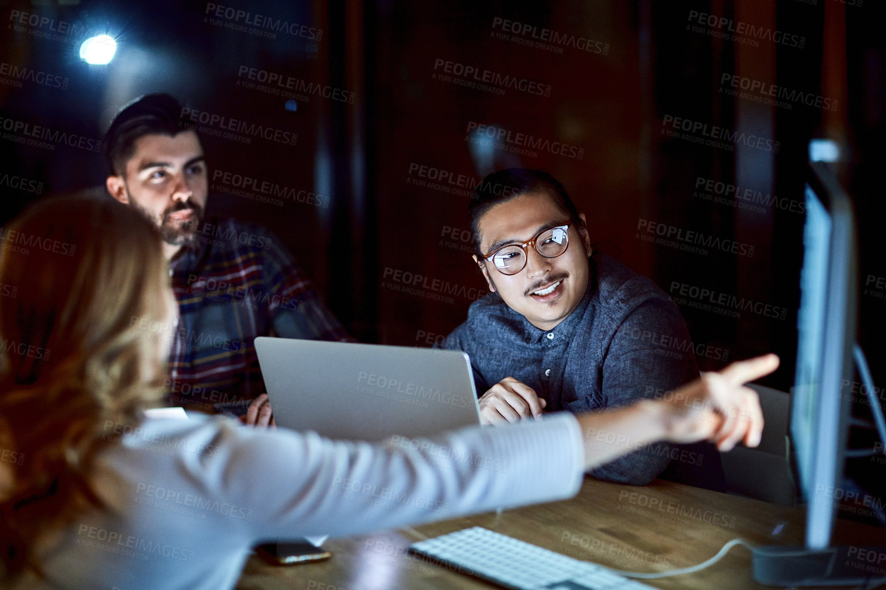 Buy stock photo Office, meeting and group with computer at night, collaboration and planning for marketing strategy. Colleagues, working late and teamwork for campaign, point and happy people with tech in agency