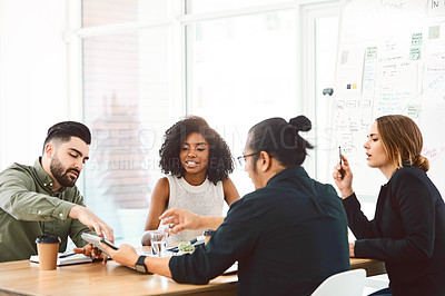 Buy stock photo Shot of a group of young businesspeople having a meeting in a modern office