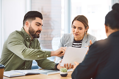 Buy stock photo Shot of a group of young businesspeople having a meeting in a modern office