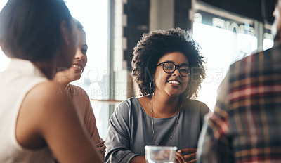 Buy stock photo Shot of a happy young diverse group sitting together in a coffee shop during the day