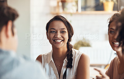 Buy stock photo Shot of an attractive young woman sitting and smiling with her friends in a coffee shop during the day