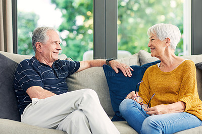 Buy stock photo Shot of a happy senior couple relaxing together on the sofa at home