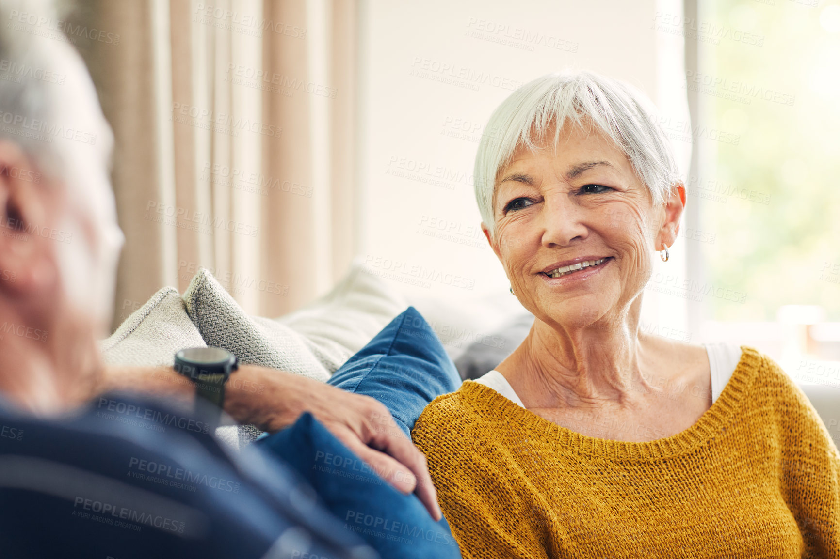 Buy stock photo Shot of a happy senior couple relaxing together on the sofa at home