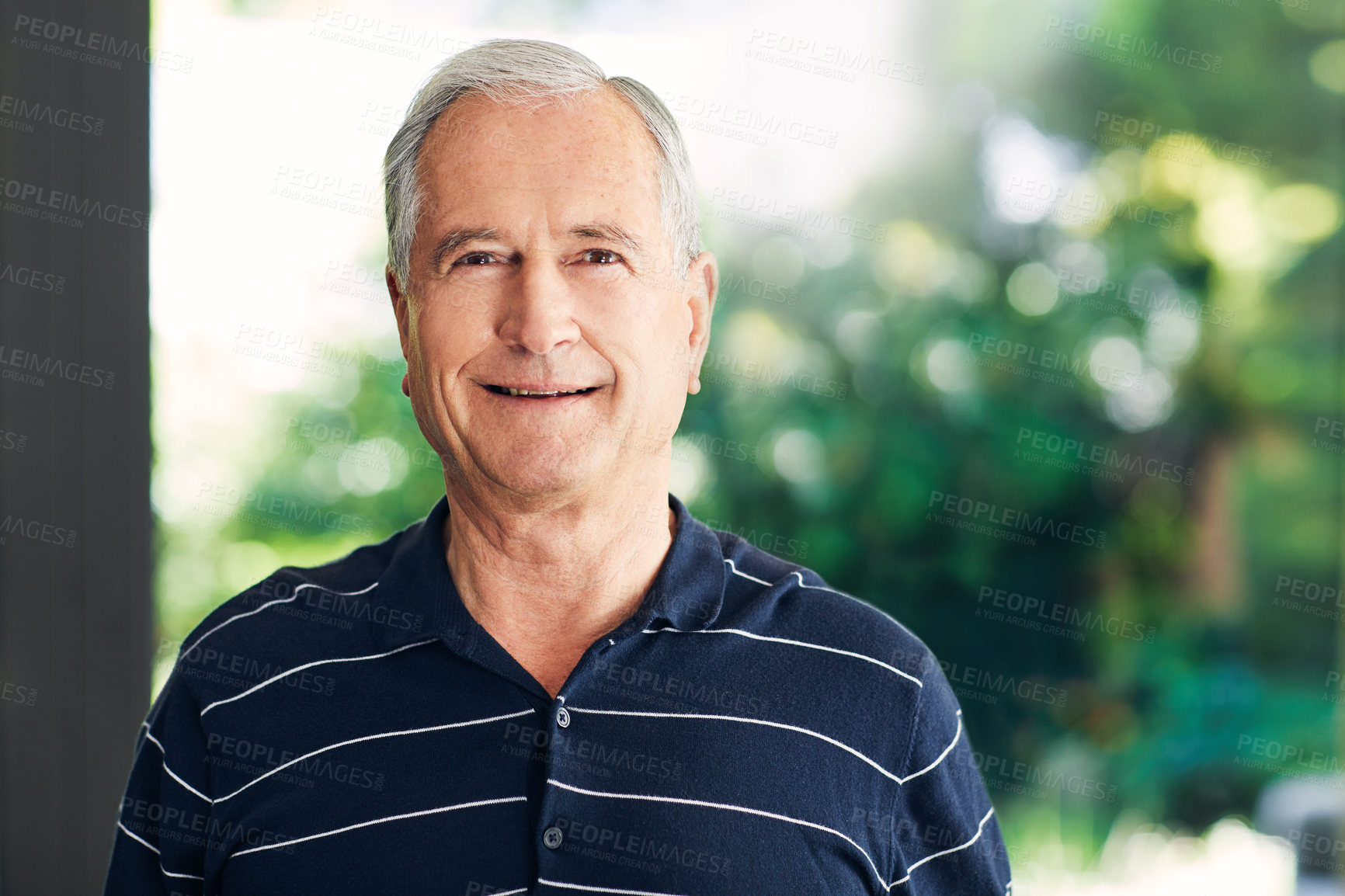 Buy stock photo Shot of a confident senior man standing in his home