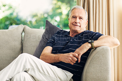 Buy stock photo Shot of a happy senior man relaxing on the sofa at home