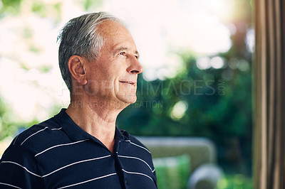 Buy stock photo Shot of a confident senior man looking thoughtful in his home