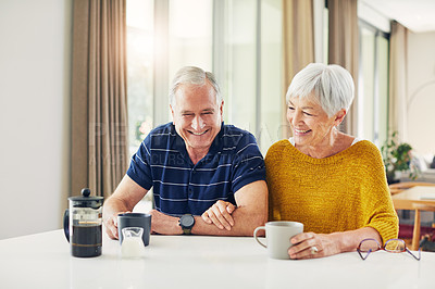 Buy stock photo Shot of a senior couple enjoying a coffee break at home