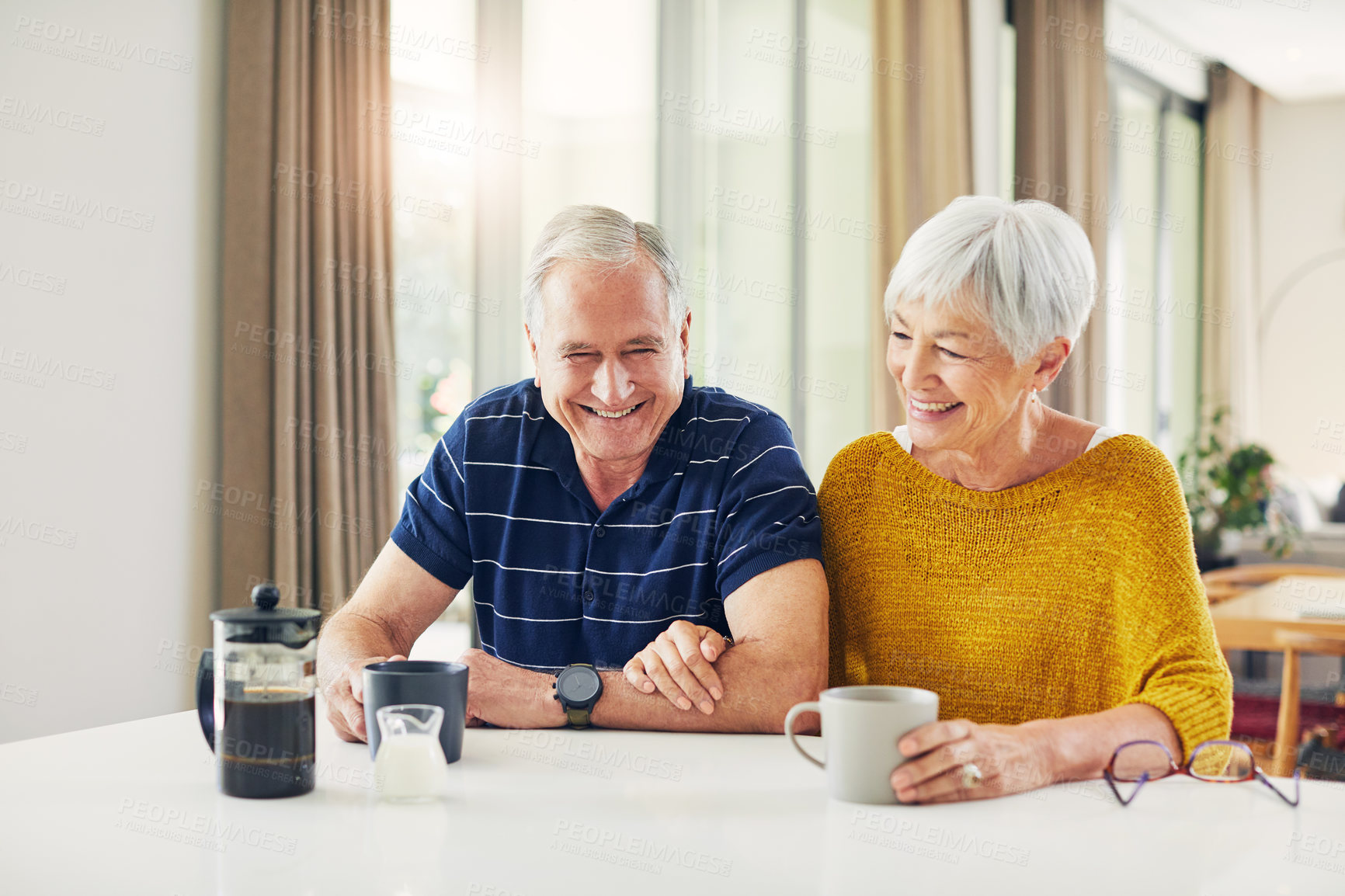 Buy stock photo Laugh, coffee and senior couple in kitchen for marriage, love and bonding at breakfast in home. Retirement, happy and elderly man and woman with drink, smile and relax in morning for commitment