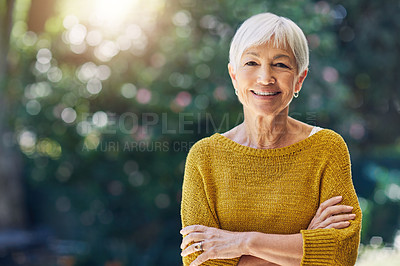 Buy stock photo Shot of a happy senior woman standing outdoors