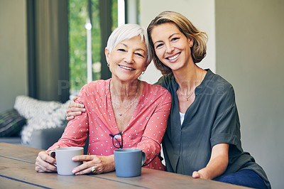 Buy stock photo Shot of a mature woman and her elderly mother having coffee and a chat at home