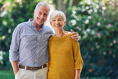 Buy stock photo Shot of a happy senior couple embracing outdoors