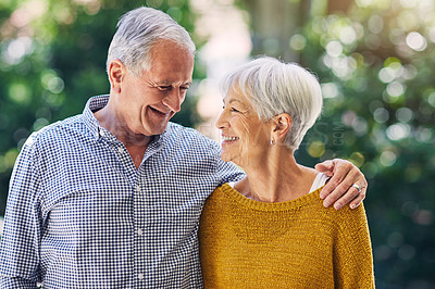 Buy stock photo Shot of a happy senior couple embracing outdoors