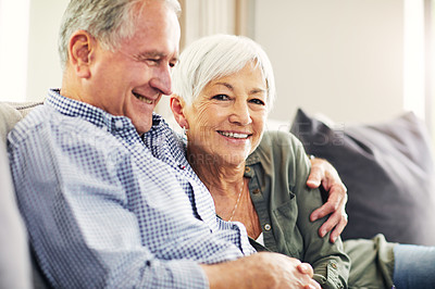 Buy stock photo Shot of a happy senior couple relaxing together on the sofa at home