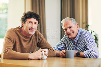 Buy stock photo Shot of a mature man and his elderly father having coffee and a chat at home