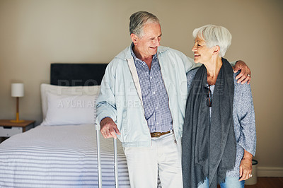 Buy stock photo Shot of a happy senior couple standing in their hotel room