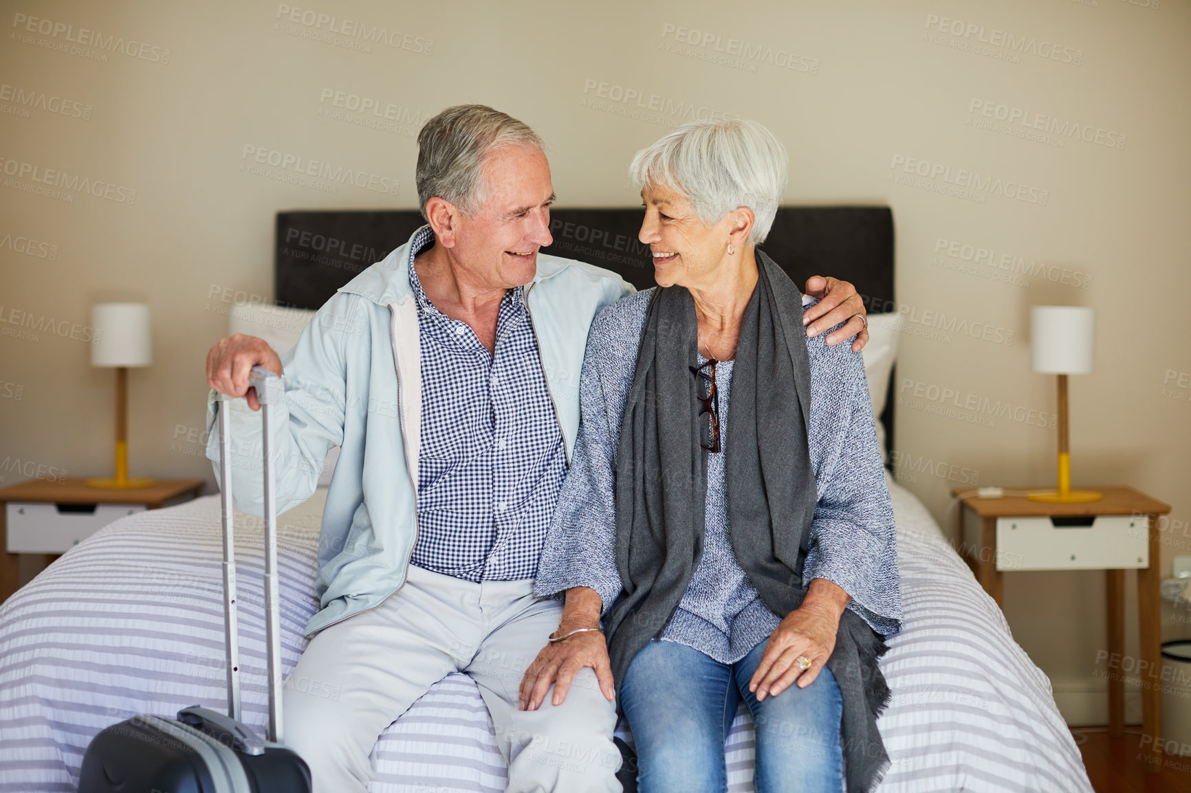 Buy stock photo Happy, old couple and relax at hotel for travel, adventure and check in for holiday getaway. Smile, senior people and embrace partner in bedroom with luggage, guest arrival and vacation at staycation