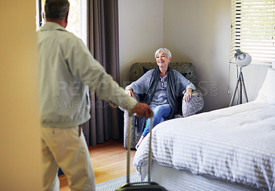 Buy stock photo Shot of a happy senior couple relaxing in their hotel room